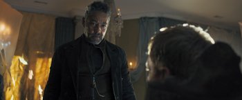 Movie still from “Maze Runner: The Scorch Trials” (2015), directed by Wes Ball – An older man in a black jacket is talking to a younger man; Medium shot, Over the shoulder angle