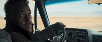 Movie still from “Maze Runner: The Scorch Trials” (2015), directed by Wes Ball – An old man driving a car in the desert; Close Up shot, Over the shoulder angle