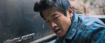 Movie still from “Maze Runner: The Scorch Trials” (2015), directed by Wes Ball – A young man with dark hair is looking down; Close Up shot, Overhead angle