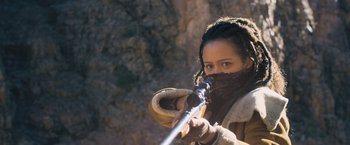 Movie still from “Maze Runner: The Scorch Trials” (2015), directed by Wes Ball – A woman holding a rifle in her hands; Close Up shot, High angle