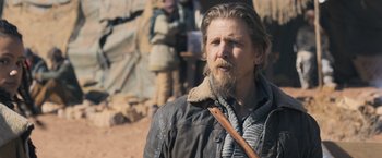 Movie still from “Maze Runner: The Scorch Trials” (2015), directed by Wes Ball – A man with long hair and a beard wearing a leather jacket; Close Up shot, Over the shoulder angle