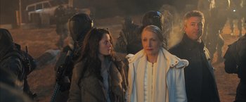 Movie still from “Maze Runner: The Scorch Trials” (2015), directed by Wes Ball – Two women standing next to each other in front of a group of soldiers; Medium shot, Over the shoulder angle