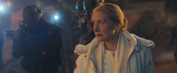 Movie still from “Maze Runner: The Scorch Trials” (2015), directed by Wes Ball – An older woman wearing a white coat looking to her left; Close Up shot, Over the shoulder angle