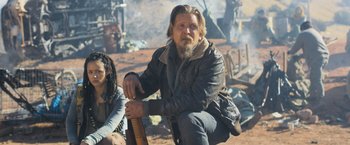 Movie still from “Maze Runner: The Scorch Trials” (2015), directed by Wes Ball – A man with a beard sitting next to a woman; Medium shot, Low angle