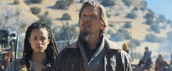 Movie still from “Maze Runner: The Scorch Trials” (2015), directed by Wes Ball – A person with a beard wearing a jacket; Medium shot, Over the shoulder angle