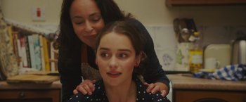 Movie still from “Me Before You” (2016), directed by Thea Sharrock – A woman is hugging a young girl's shoulders; Close Up shot, Over the shoulder angle