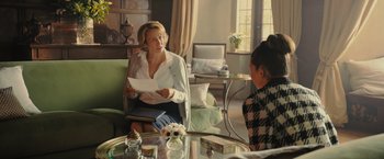 Movie still from “Me Before You” (2016), directed by Thea Sharrock – Two women sitting at a table in a living room; Medium shot, Over the shoulder angle