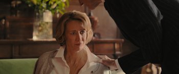 Movie still from “Me Before You” (2016), directed by Thea Sharrock – A woman sitting in front of a man with a hand on her shoulder; Close Up shot, Over the shoulder angle