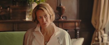 Movie still from “Me Before You” (2016), directed by Thea Sharrock – A person with short hair wearing a white shirt; Close Up shot, Over the shoulder angle