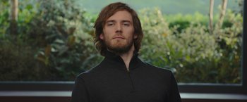 Movie still from “Me Before You” (2016), directed by Thea Sharrock – A person with long hair and a beard; Close Up shot, Low angle