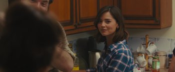 Movie still from “Me Before You” (2016), directed by Thea Sharrock – A woman in a plaid shirt is holding a man's arm; Close Up shot, Over the shoulder angle