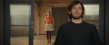 Movie still from “Me Before You” (2016), directed by Thea Sharrock – A man and a woman standing in front of each other; Medium shot, Over the shoulder angle