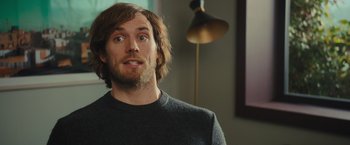 Movie still from “Me Before You” (2016), directed by Thea Sharrock – A person wearing a sweater; Close Up shot, Over the shoulder angle