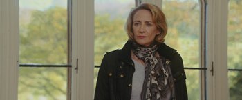 Movie still from “Me Before You” (2016), directed by Thea Sharrock – A person wearing a jacket and a scarf; Close Up shot, Over the shoulder angle
