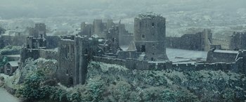 Movie still from “Me Before You” (2016), directed by Thea Sharrock – A view of a castle from a hill; Extreme Wide shot, High angle