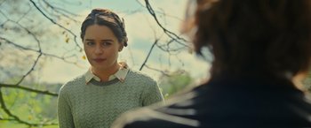 Movie still from “Me Before You” (2016), directed by Thea Sharrock – A woman in a green sweater looking at a man in a white shirt; Close Up shot, Over the shoulder angle