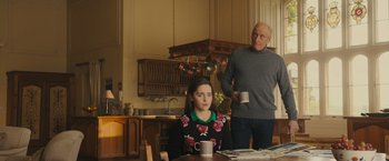 Movie still from “Me Before You” (2016), directed by Thea Sharrock – A man and a woman are drinking coffee in a kitchen; Medium shot, Over the shoulder angle