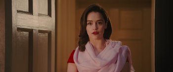 Movie still from “Me Before You” (2016), directed by Thea Sharrock – A woman in a red shirt and a pink scarf; Close Up shot, Over the shoulder angle