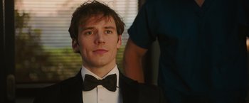 Movie still from “Me Before You” (2016), directed by Thea Sharrock – A man in a suit and a bow tie; Close Up shot, Over the shoulder angle