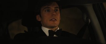 Movie still from “Me Before You” (2016), directed by Thea Sharrock – A man in a suit and a bow tie looking up; Close Up shot, Low angle