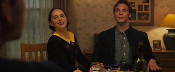 Movie still from “Me Before You” (2016), directed by Thea Sharrock – A man and a woman sitting at a dinner table; Medium shot, Over the shoulder angle
