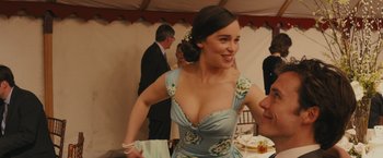 Movie still from “Me Before You” (2016), directed by Thea Sharrock – A beautiful young lady in a blue floral dress; Medium shot, Over the shoulder angle
