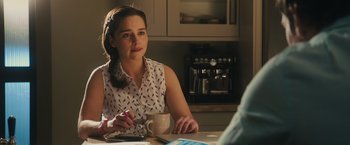 Movie still from “Me Before You” (2016), directed by Thea Sharrock – A woman sitting at a table with a cup of coffee; Close Up shot, Over the shoulder angle