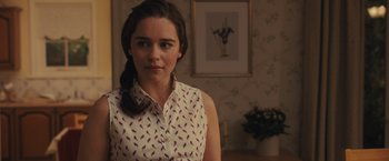 Movie still from “Me Before You” (2016), directed by Thea Sharrock – A woman in a white shirt is standing in a room; Close Up shot, Over the shoulder angle
