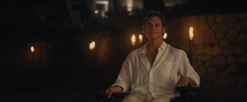 Movie still from “Me Before You” (2016), directed by Thea Sharrock – A man in a white shirt is holding a camera; Medium shot, Over the shoulder angle