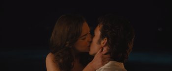 Movie still from “Me Before You” (2016), directed by Thea Sharrock – A man and a woman kissing in the dark; Close Up shot, Over the shoulder angle