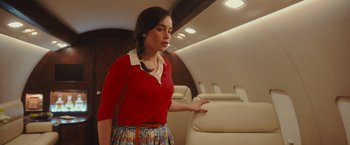 Movie still from “Me Before You” (2016), directed by Thea Sharrock – A woman in a red shirt is standing on a plane; Medium shot, High angle