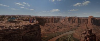 Movie still from “Me Time” (2022), directed by John Hamburg – A group of people standing on top of a cliff overlooking a river; Extreme Wide shot, High angle