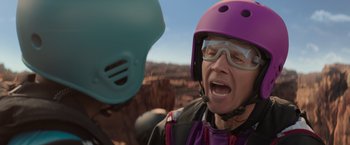 Movie still from “Me Time” (2022), directed by John Hamburg – A man wearing a purple helmet and a purple jacket; Close Up shot, Over the shoulder angle