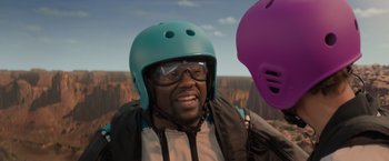 Movie still from “Me Time” (2022), directed by John Hamburg – A man wearing a blue helmet and goggles; Close Up shot, Over the shoulder angle