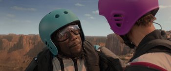 Movie still from “Me Time” (2022), directed by John Hamburg – A man wearing a blue helmet and goggles; Close Up shot, Over the shoulder angle