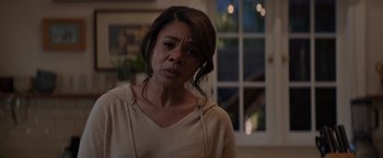 Movie still from “Me Time” (2022), directed by John Hamburg – A person wearing a sweater near a window; Close Up shot, Over the shoulder angle