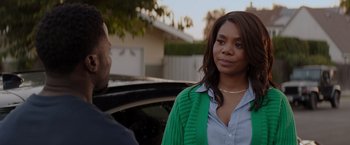 Movie still from “Me Time” (2022), directed by John Hamburg – A woman standing next to a man in front of a black car; Close Up shot, Over the shoulder angle
