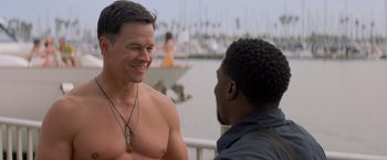 Movie still from “Me Time” (2022), directed by John Hamburg – Two men are talking and smiling at each other; Close Up shot, Over the shoulder angle