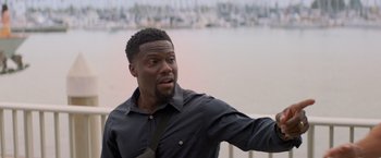 Movie still from “Me Time” (2022), directed by John Hamburg – A person wearing a shirt and tie; Medium shot, Over the shoulder angle