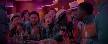 Movie still from “Me Time” (2022), directed by John Hamburg – A group of people sitting at a table with a glass of red wine; Medium shot, Over the shoulder angle