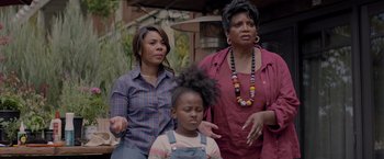 Movie still from “Me Time” (2022), directed by John Hamburg – Two women and a child are standing together; Medium shot, Over the shoulder angle