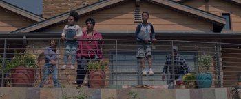 Movie still from “Me Time” (2022), directed by John Hamburg – A group of people standing next to each other on top of a railing; Wide shot, Low angle