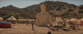 Movie still from “Me Time” (2022), directed by John Hamburg – A man that is made out of sand; Extreme Wide shot, Low angle