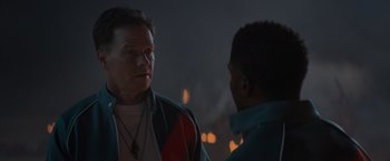 Movie still from “Me Time” (2022), directed by John Hamburg – Two men are standing in front of a burning building; Close Up shot, Over the shoulder angle