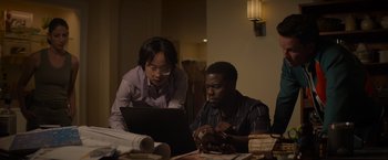 Movie still from “Me Time” (2022), directed by John Hamburg – A man and a woman are looking at a laptop computer; Medium shot, Over the shoulder angle