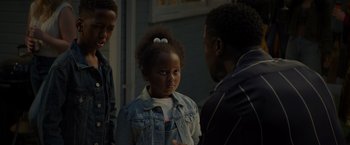 Movie still from “Me Time” (2022), directed by John Hamburg – A little girl standing next to two men; Close Up shot, Over the shoulder angle