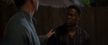 Movie still from “Me Time” (2022), directed by John Hamburg – A man is talking to another man who is holding a knife; Close Up shot, Over the shoulder angle