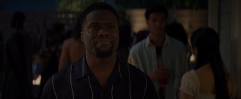 Movie still from “Me Time” (2022), directed by John Hamburg – A man in a black and white striped shirt looking up; Close Up shot, Over the shoulder angle