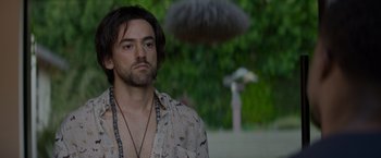 Movie still from “Me Time” (2022), directed by John Hamburg – A person with a beard; Close Up shot, Over the shoulder angle