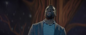 Movie still from “Me Time” (2022), directed by John Hamburg – A man in a gray jacket looking up at the sky; Close Up shot, Low angle